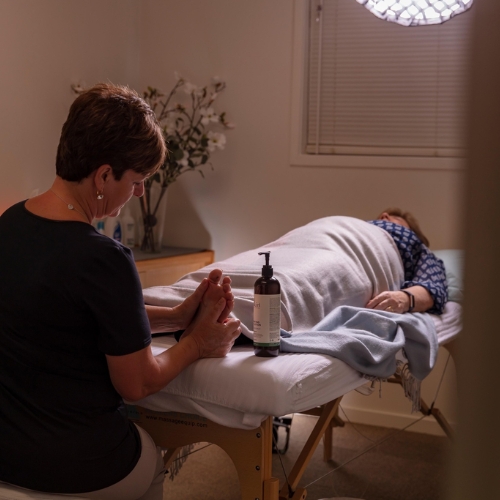 A photo of a Choices team member giving a cancer patient a relaxing foot massage in a calm and tranquil space at The Wesley A photo of a Choices team member giving a cancer patient a relaxing foot massage in a calm and tranquil space at The Wesley