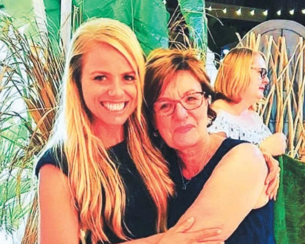 A photo of Carly and her Mum holding each other close and smiling warmly A photo of Carly and her Mum holding each other close and smiling warmly