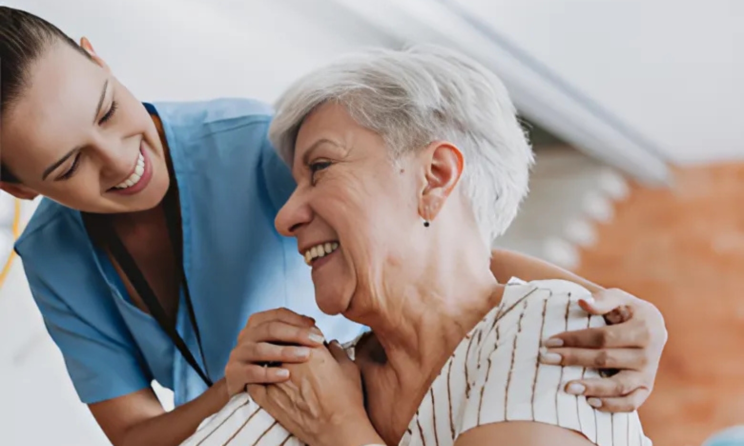 An older woman and a healthcare team member are enjoying a moment together An older woman and a healthcare team member are enjoying a moment together