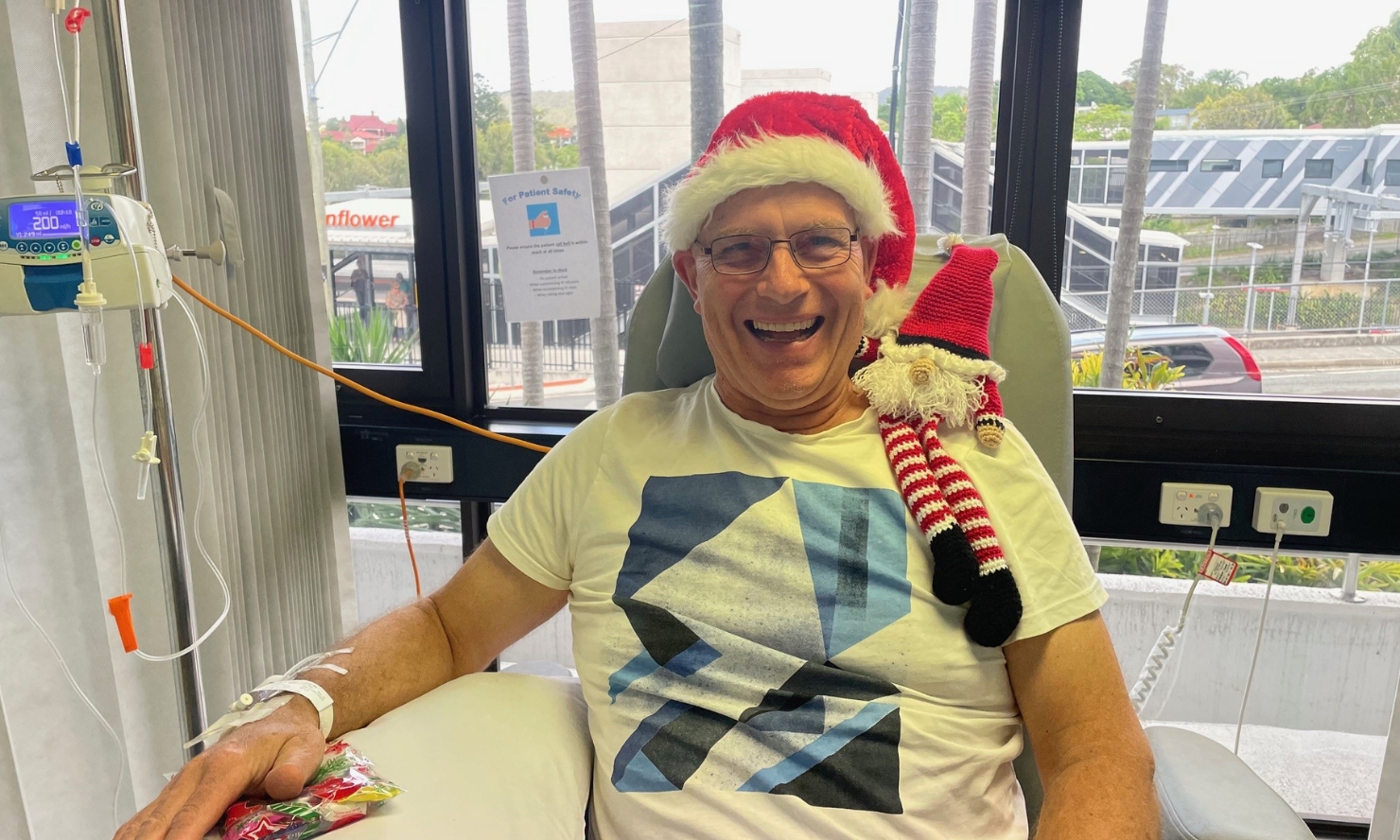 Duncan is in treatment at The Wesley. Duncan is wearing a festive santa hat and smiling widely.