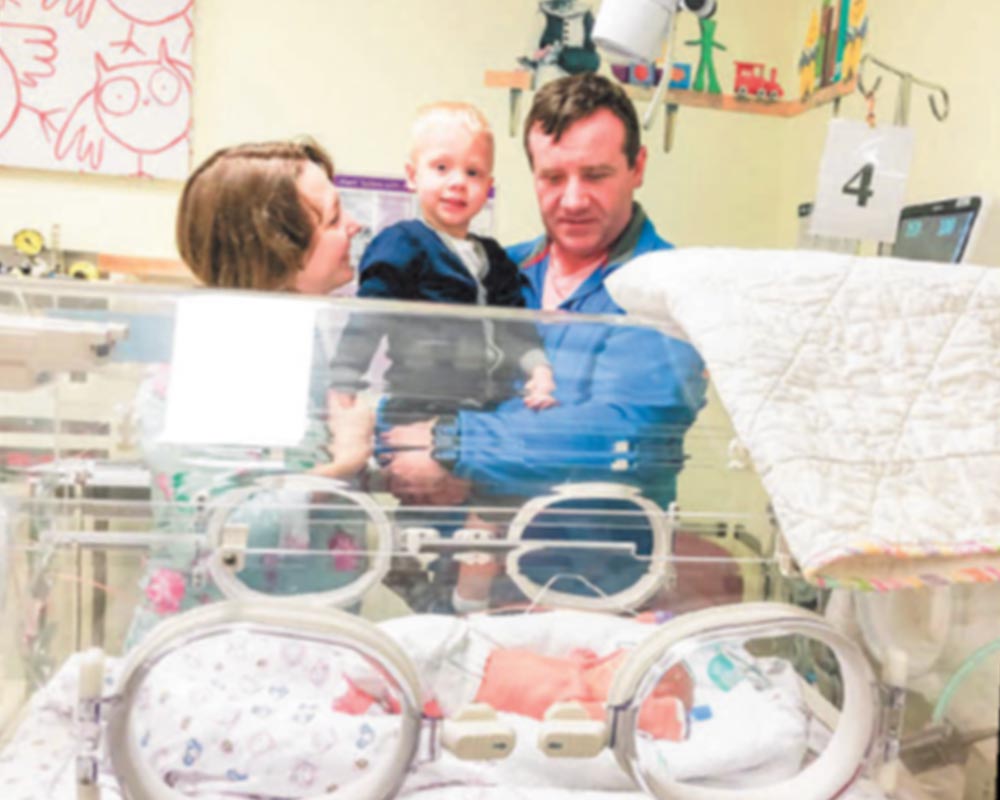 Claire, Seamus and Sacha are looking over baby Shiloh in a Special Care Nursery crib Claire, Seamus and Sacha are looking over baby Shiloh in a Special Care Nursery crib