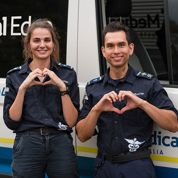 Two medics standing in front of an ambulance